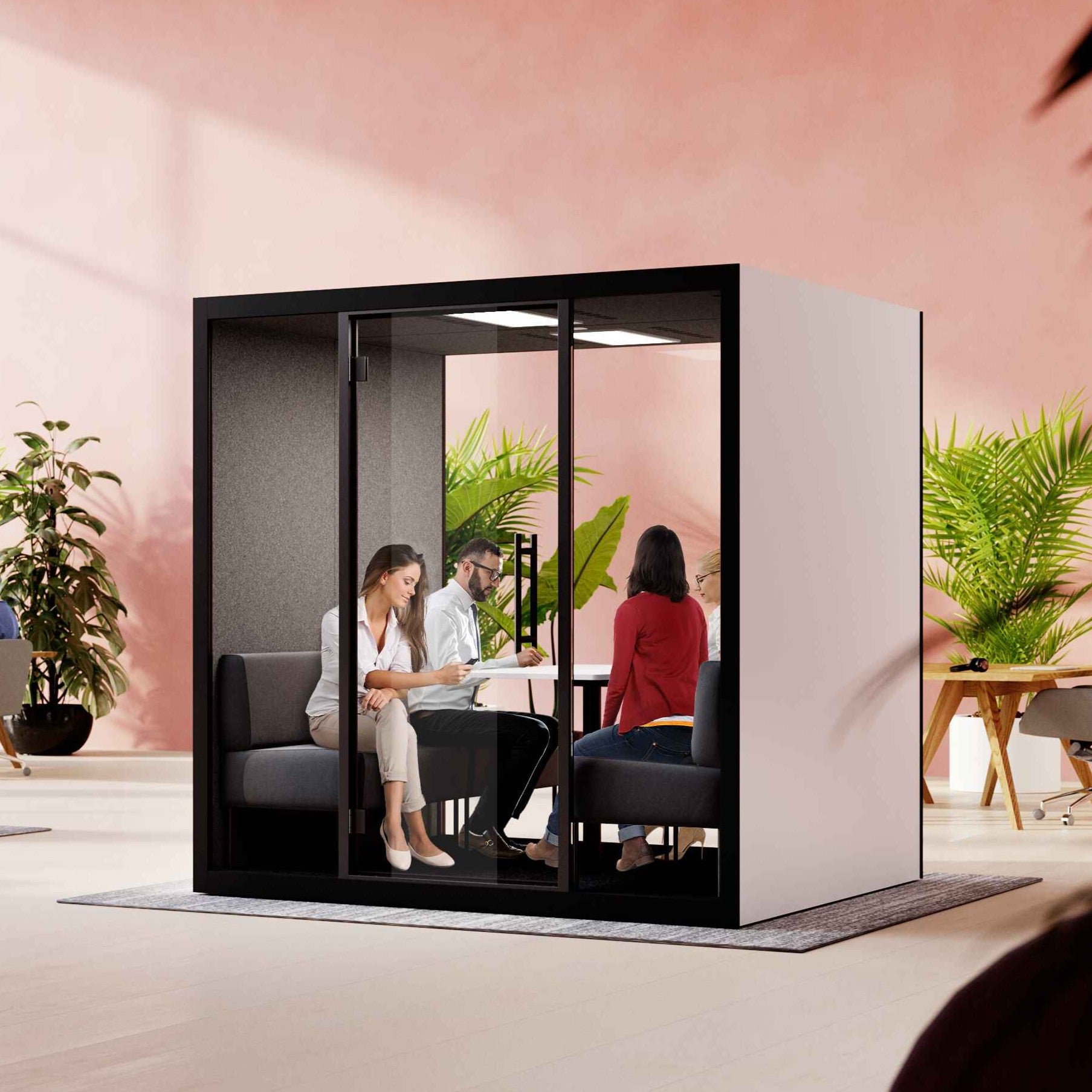 Innenansicht der Chatbox Quattro Akustikbox mit vier Sitzplaetzen, grossem Tisch und LED-Beleuchtung – komfortable Loesung fuer Besprechungen in akustisch geschuetzter Umgebung