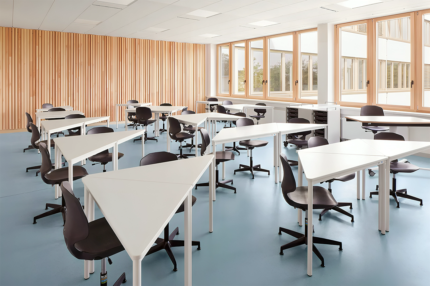 Moderne Schulmoebel im Einsatz, mit ergonomischen Stuehlen und funktionalen Tischen, die eine produktive und komfortable Lernumgebung bieten, praesentiert von Kibemo