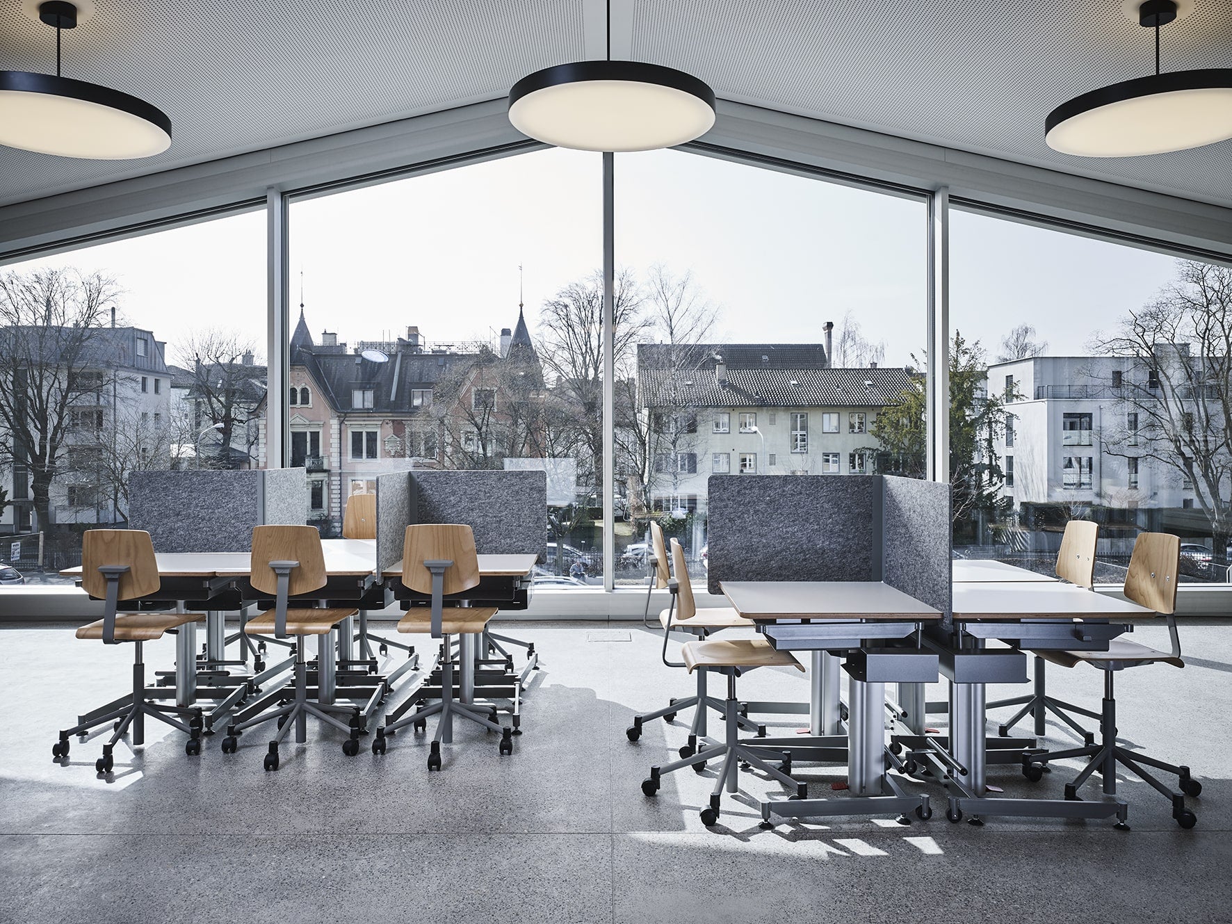 Moderner Klassenraum mit ergonomischen Schulmoebeln, darunter robuste Tische und Stuehle, sowie einer klaren und funktionalen Raumgestaltung, ideal fuer eine produktive Lernumgebung, praesentiert von Kibemo